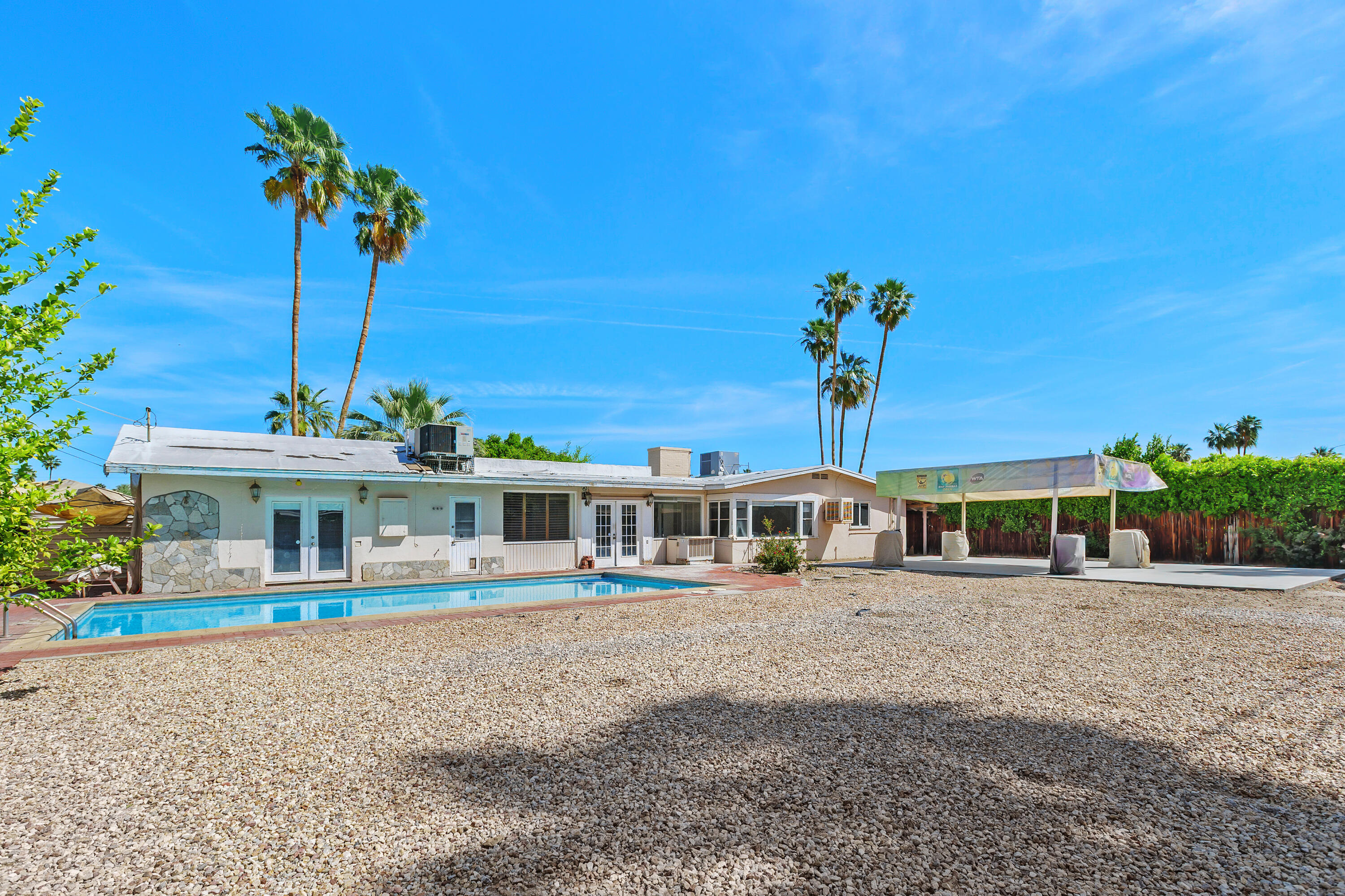 1077 South Riverside Drive Palm Springs, CA 92264 - Photo 3 of 35 a view of a house with a swimming pool