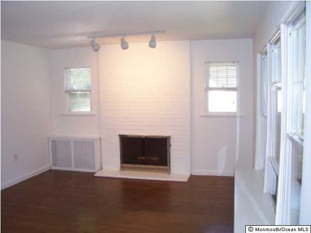 54 Little Silver Point Road Little Silver, NJ 07739 - Photo 3 of 3 a view of an empty room with wooden floor and a window