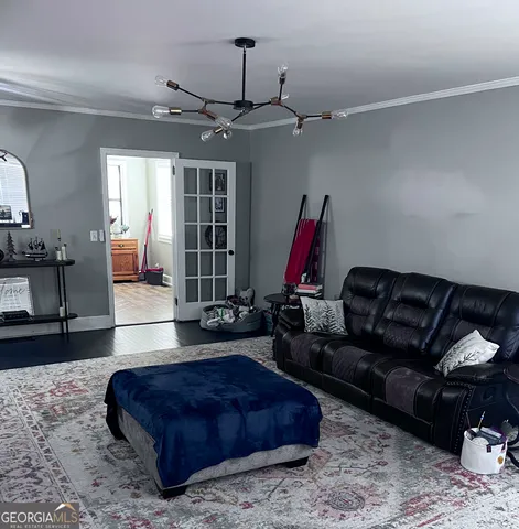 a living room with furniture a ceiling fan and a rug