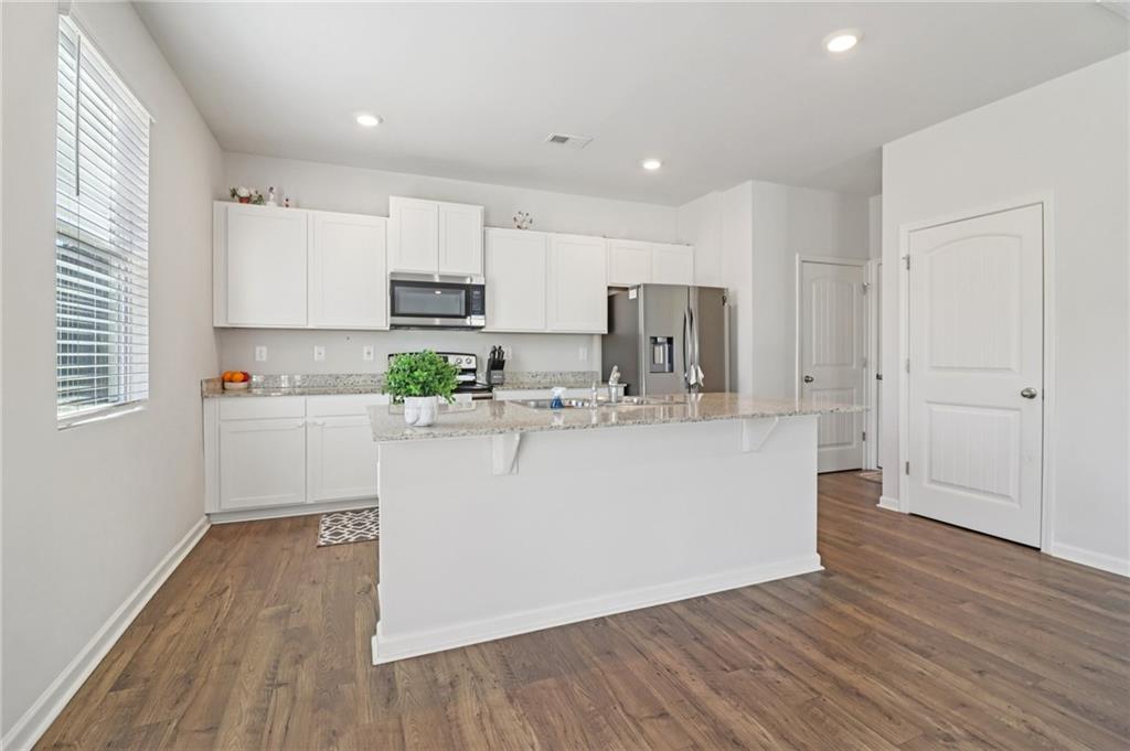 113 Deer Run Drive Dallas, GA 30132 - Photo 7 of 25 a view of kitchen with wooden floor and electronic appliances