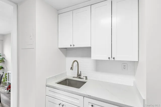 a kitchen with a sink and cabinets
