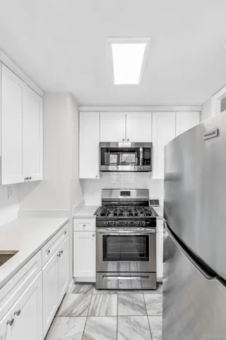 a kitchen with cabinets and appliances