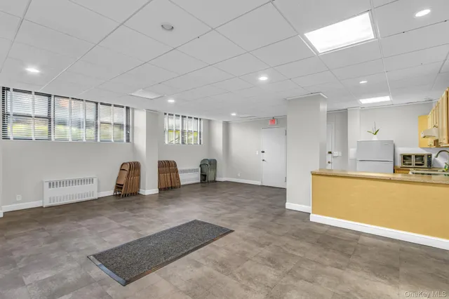 a utility room with dryer washer and a view of kitchen