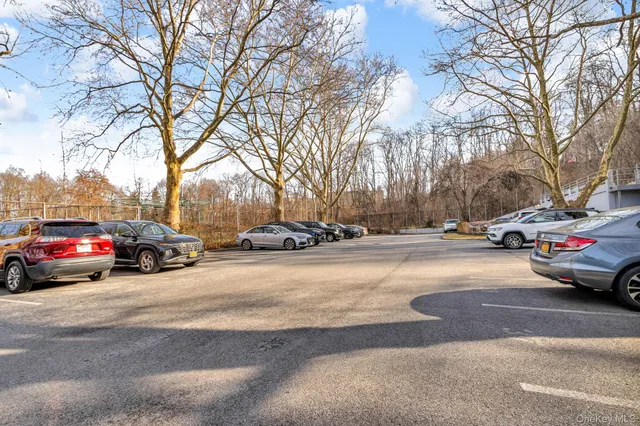 a swimming pool with outdoor seating and trees