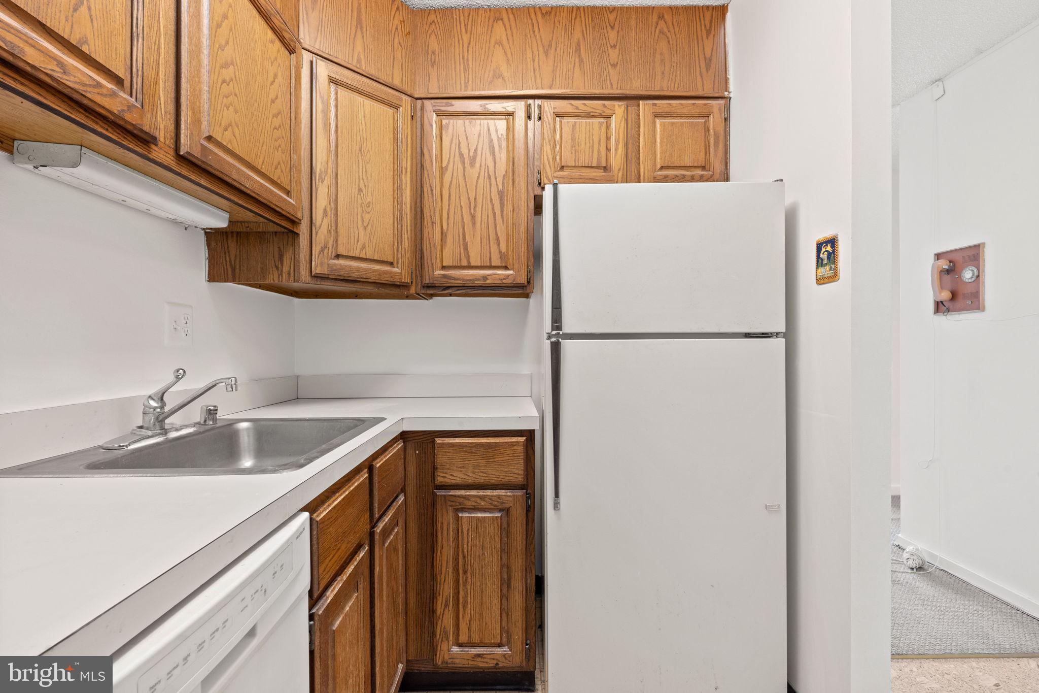 300 M Street Southwest, Unit N213 Washington, DC 20024 - Photo 7 of 14 a white refrigerator freezer sitting inside of a kitchen