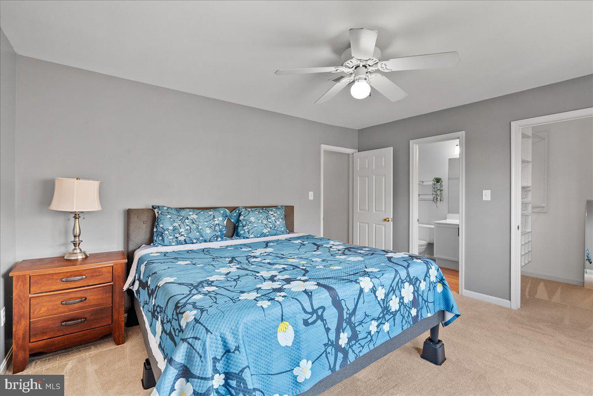7930 Minor Hill Road Manassas, VA 20109 - Photo 15 of 26 a bedroom with a bed and a chandelier