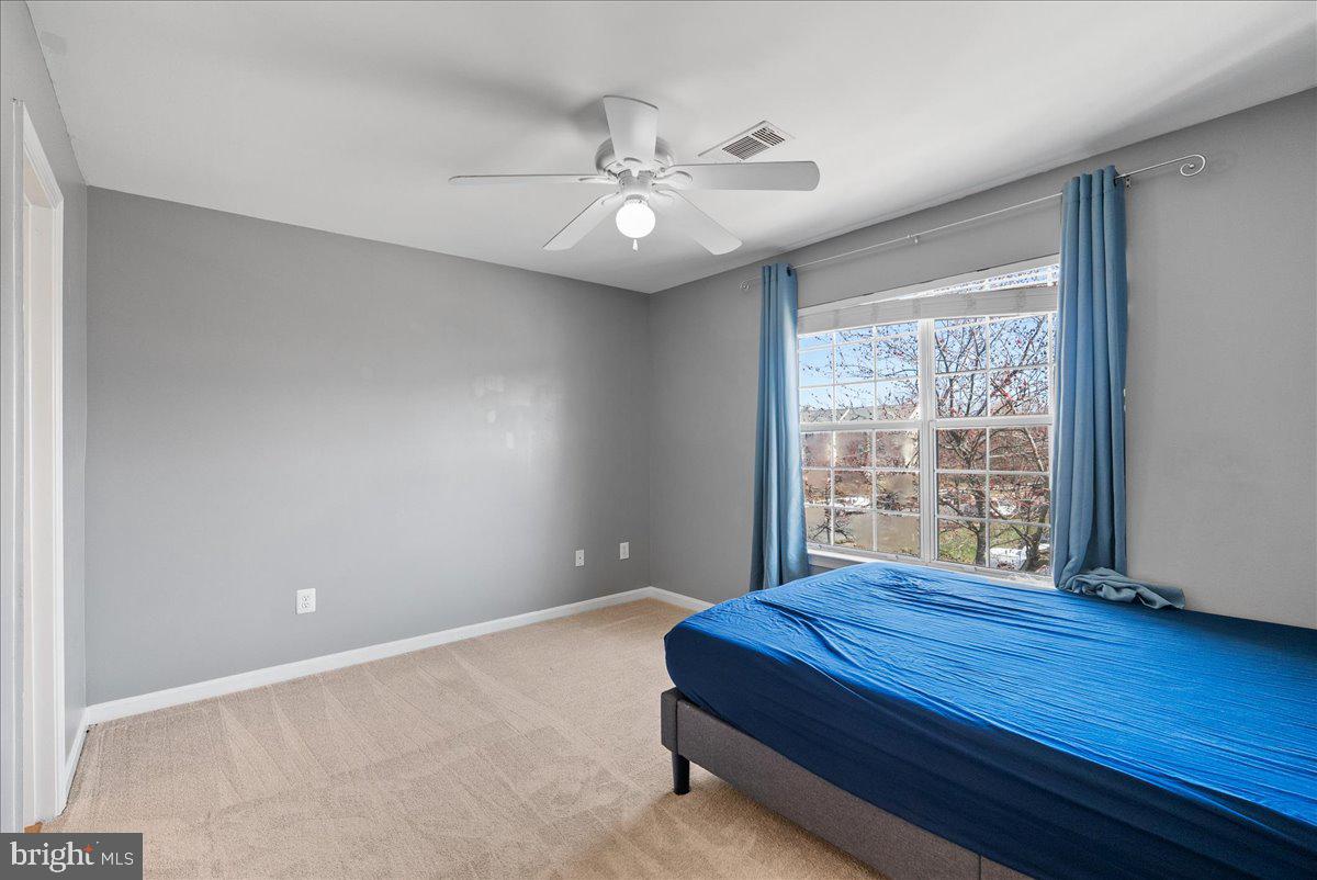7930 Minor Hill Road Manassas, VA 20109 - Photo 20 of 26 a bedroom with a large bed and a chandelier