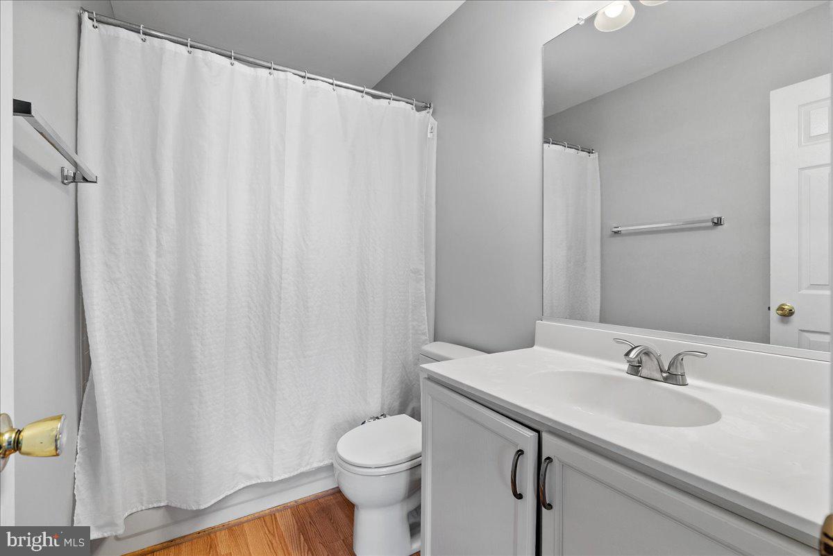 7930 Minor Hill Road Manassas, VA 20109 - Photo 21 of 26 a bathroom with a sink a toilet and shower curtain