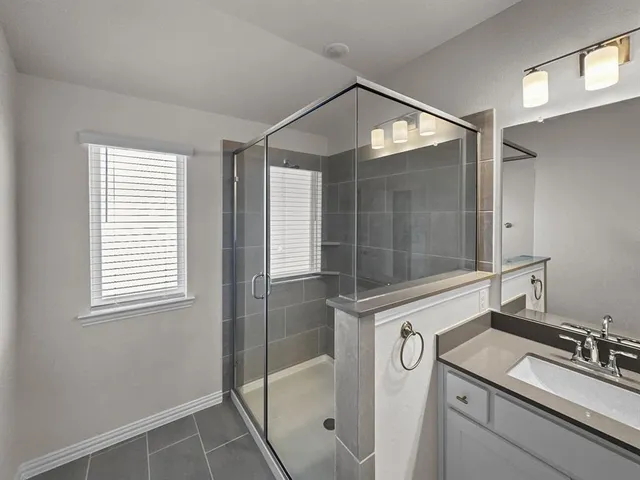 an empty room with closet and a ceiling fan