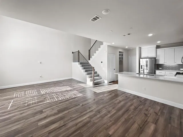 a kitchen with granite countertop kitchen island a sink and a window