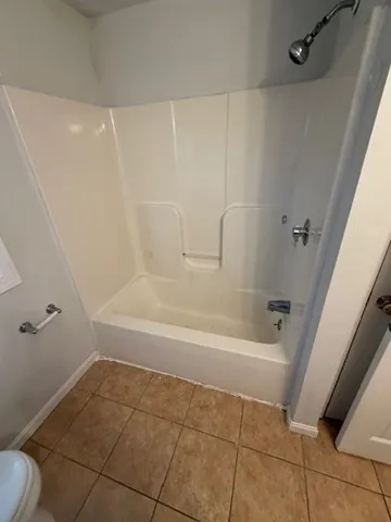 a bathroom with a shower and a toilet
