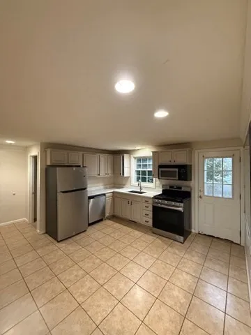 a kitchen with a refrigerator and a sink