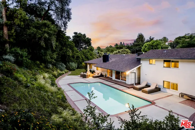 an aerial view of a house with a garden and trees
