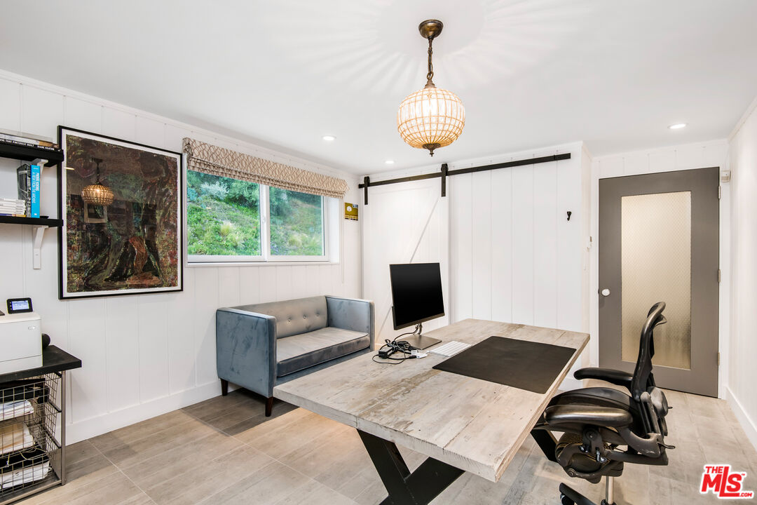 16849 Adlon Road Encino, CA 91436 - Photo 13 of 40 a view of a workspace with furniture and a window