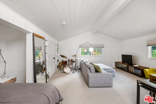 a bedroom with furniture and a flat screen tv