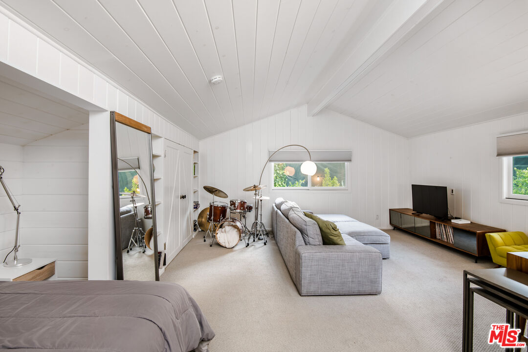 16849 Adlon Road Encino, CA 91436 - Photo 14 of 40 a bedroom with furniture and a flat screen tv