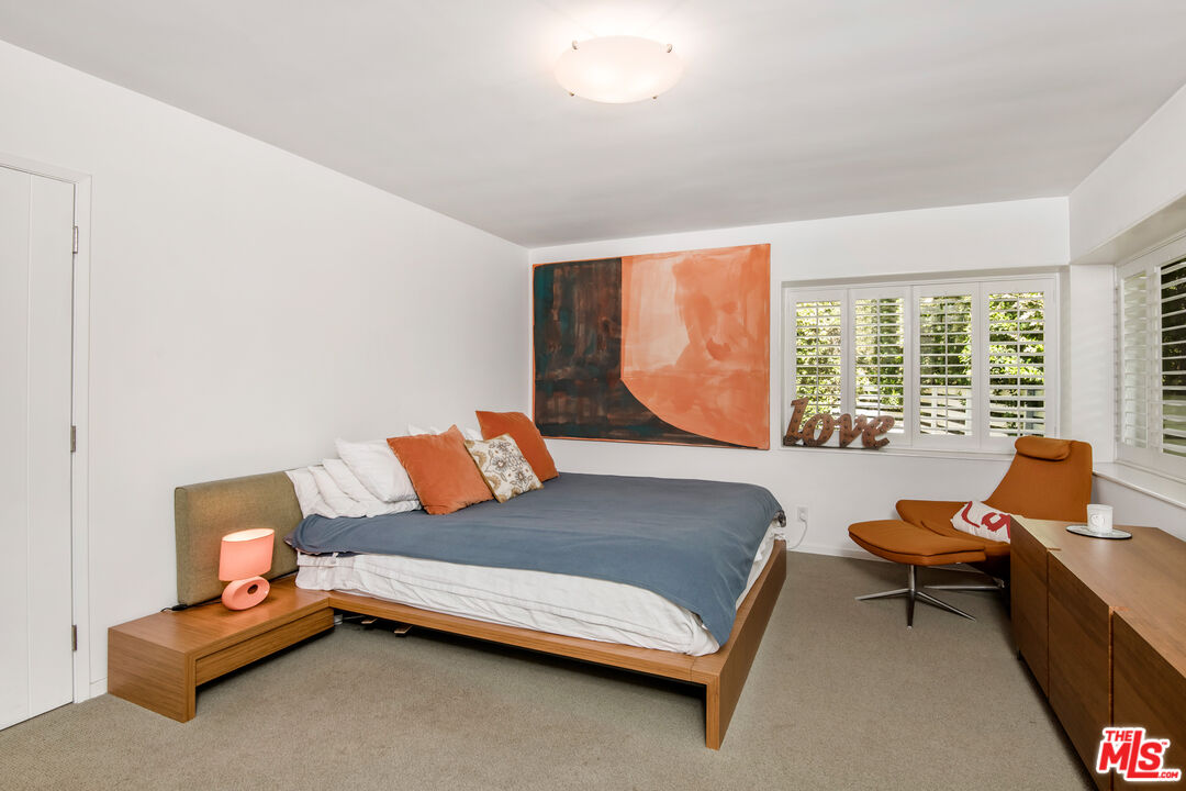 16849 Adlon Road Encino, CA 91436 - Photo 15 of 40 a bedroom with furniture and large windows