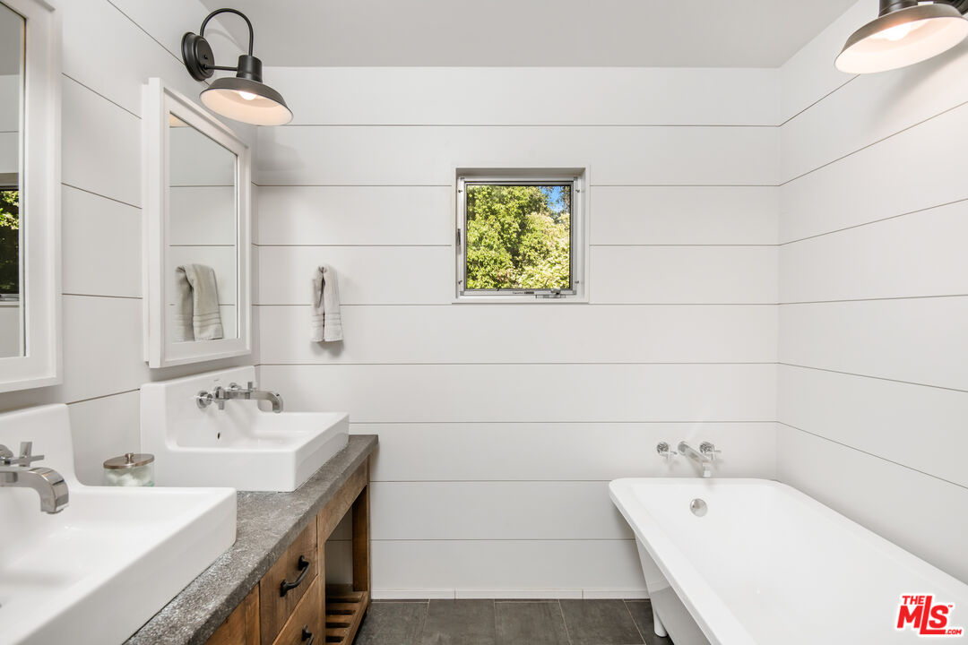 16849 Adlon Road Encino, CA 91436 - Photo 16 of 40 a bathroom with a sink a toilet and mirror