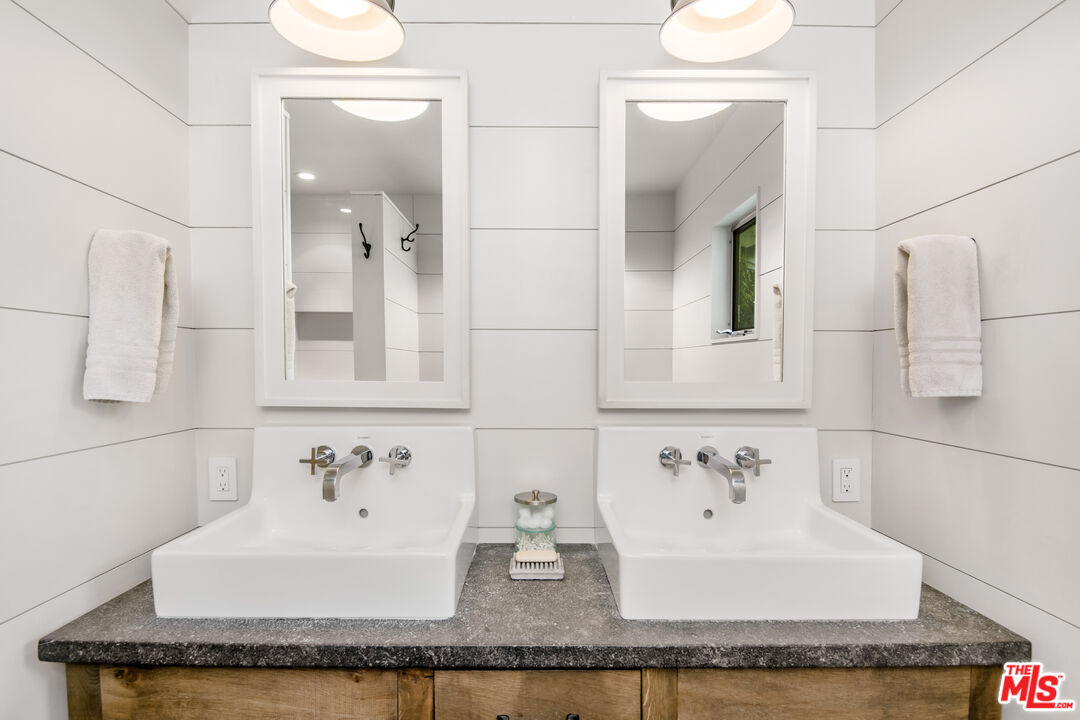 16849 Adlon Road Encino, CA 91436 - Photo 17 of 40 a bathroom with a granite countertop sink and a mirror
