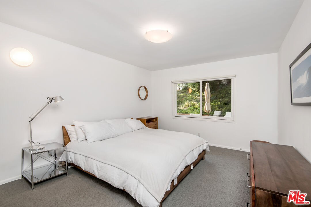 16849 Adlon Road Encino, CA 91436 - Photo 19 of 40 a bedroom with a bed and window