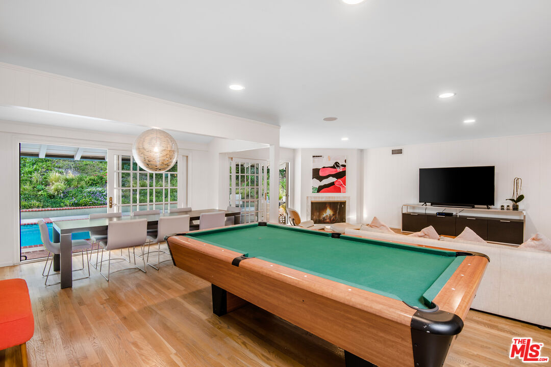 16849 Adlon Road Encino, CA 91436 - Photo 22 of 40 a living room with furniture and a flat screen tv