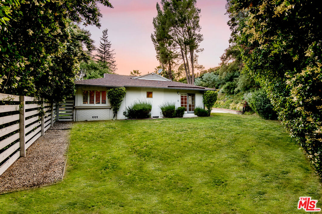 16849 Adlon Road Encino, CA 91436 - Photo 25 of 40 a front view of a house with a yard