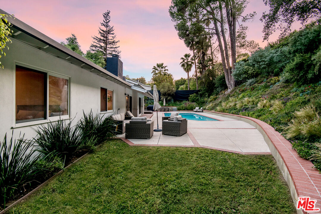 16849 Adlon Road Encino, CA 91436 - Photo 26 of 40 a view of a patio with table and chairs potted plants with large tree