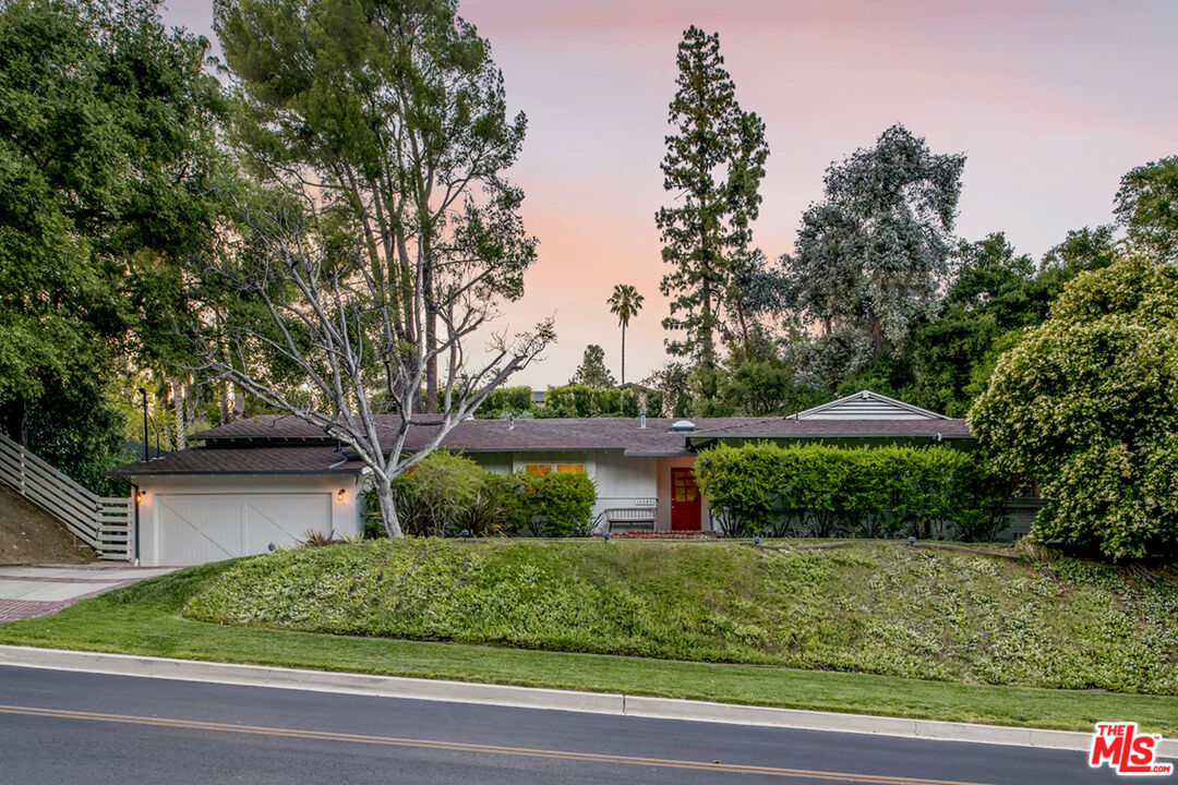 16849 Adlon Road Encino, CA 91436 - Photo 27 of 40 a front view of a house with a yard
