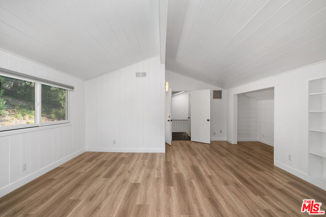 16849 Adlon Road Encino, CA 91436 - Photo 32 of 40 a view of a big room with wooden floor and windows