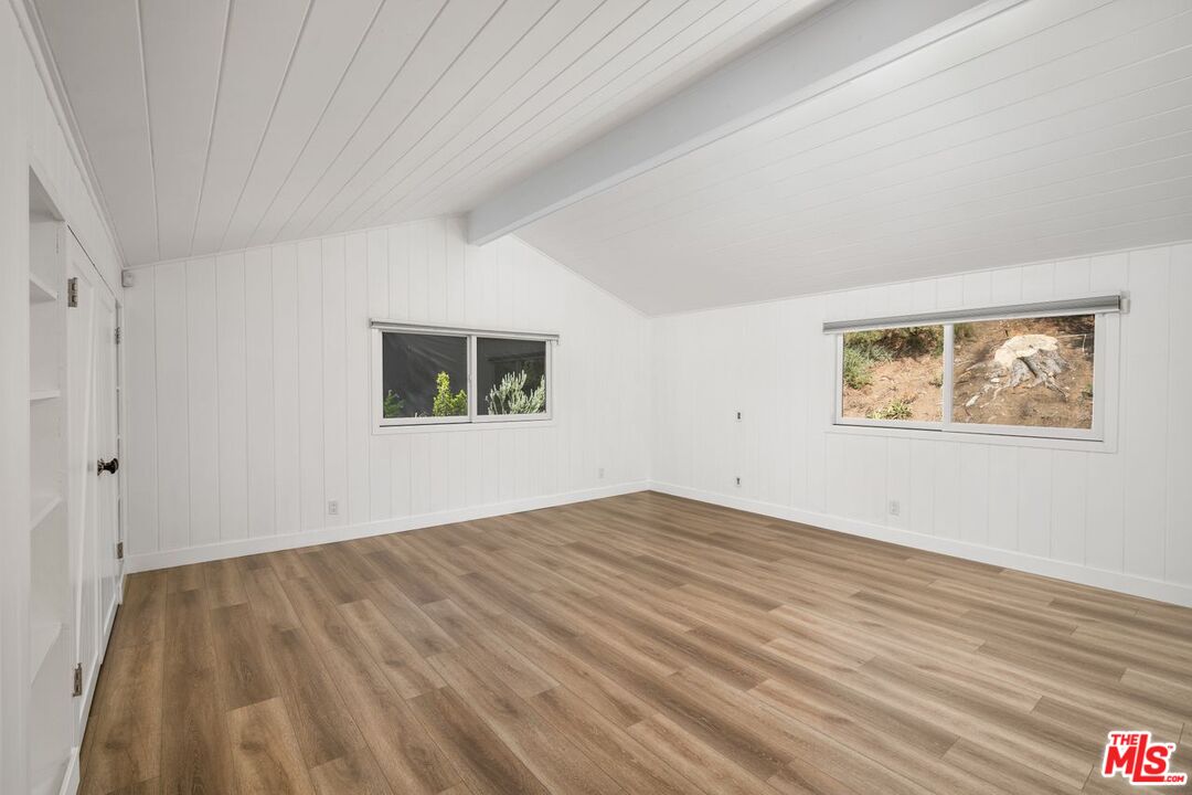 16849 Adlon Road Encino, CA 91436 - Photo 38 of 40 a view of an empty room with wooden floor and a window
