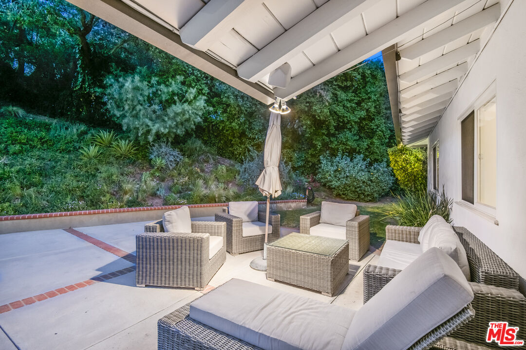 16849 Adlon Road Encino, CA 91436 - Photo 4 of 40 a view of a patio with couches table and chairs and potted plants