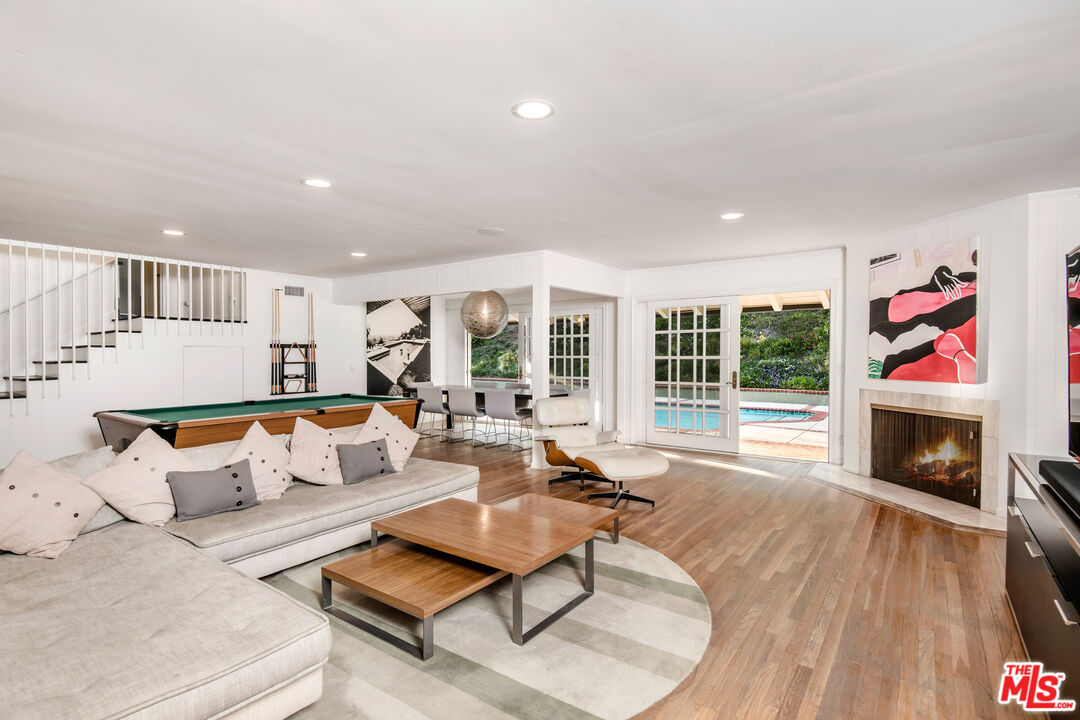 16849 Adlon Road Encino, CA 91436 - Photo 5 of 40 a living room with furniture fireplace and flat screen tv
