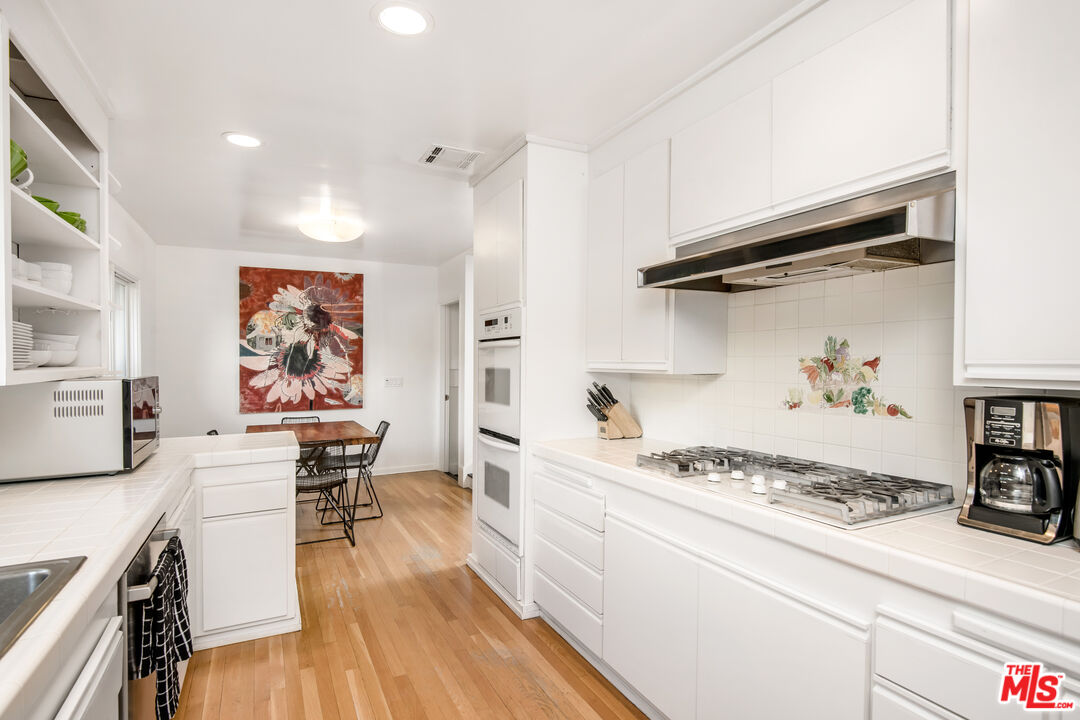 16849 Adlon Road Encino, CA 91436 - Photo 9 of 40 a kitchen with a table and chairs