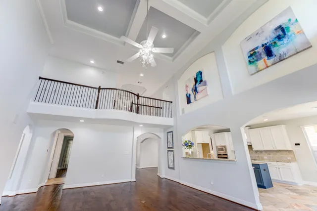 a view of a hallway with entryway wooden floor and front door
