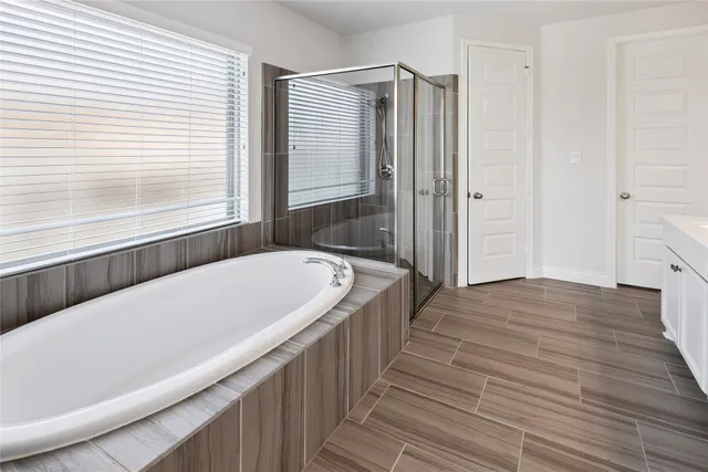 a bathroom with a bathtub and a shower