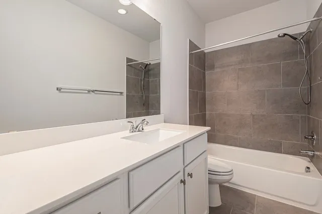 a bathroom with a sink toilet vanity and shower