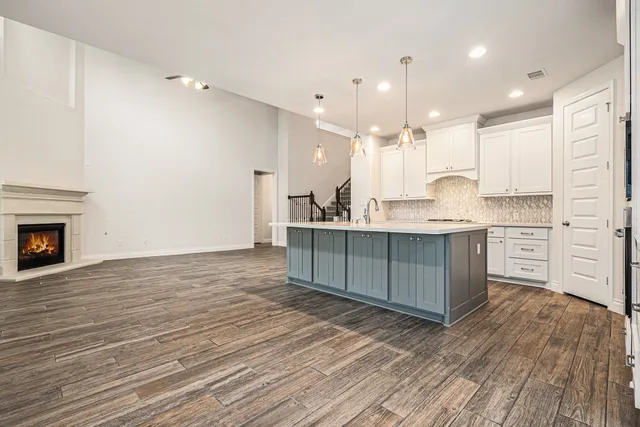 a large kitchen with kitchen island a sink stainless steel appliances and cabinets