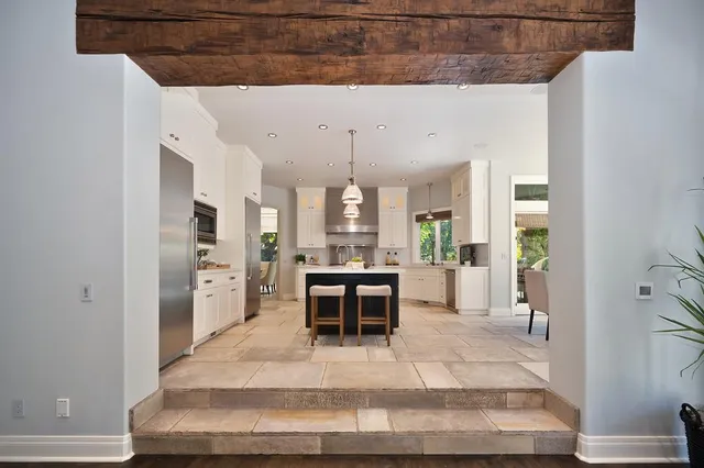 a spacious bedroom with a balcony a bed and a flat screen tv