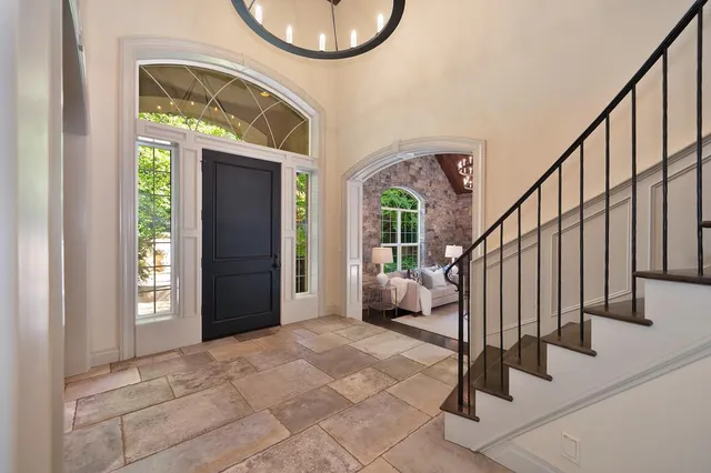a living room with furniture and a chandelier