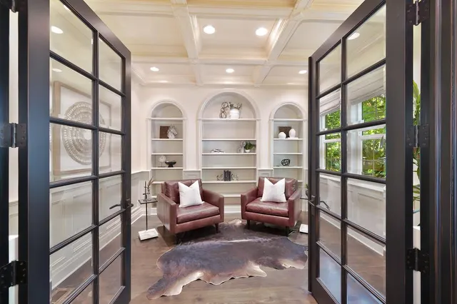 a living room with furniture chandelier and a rug