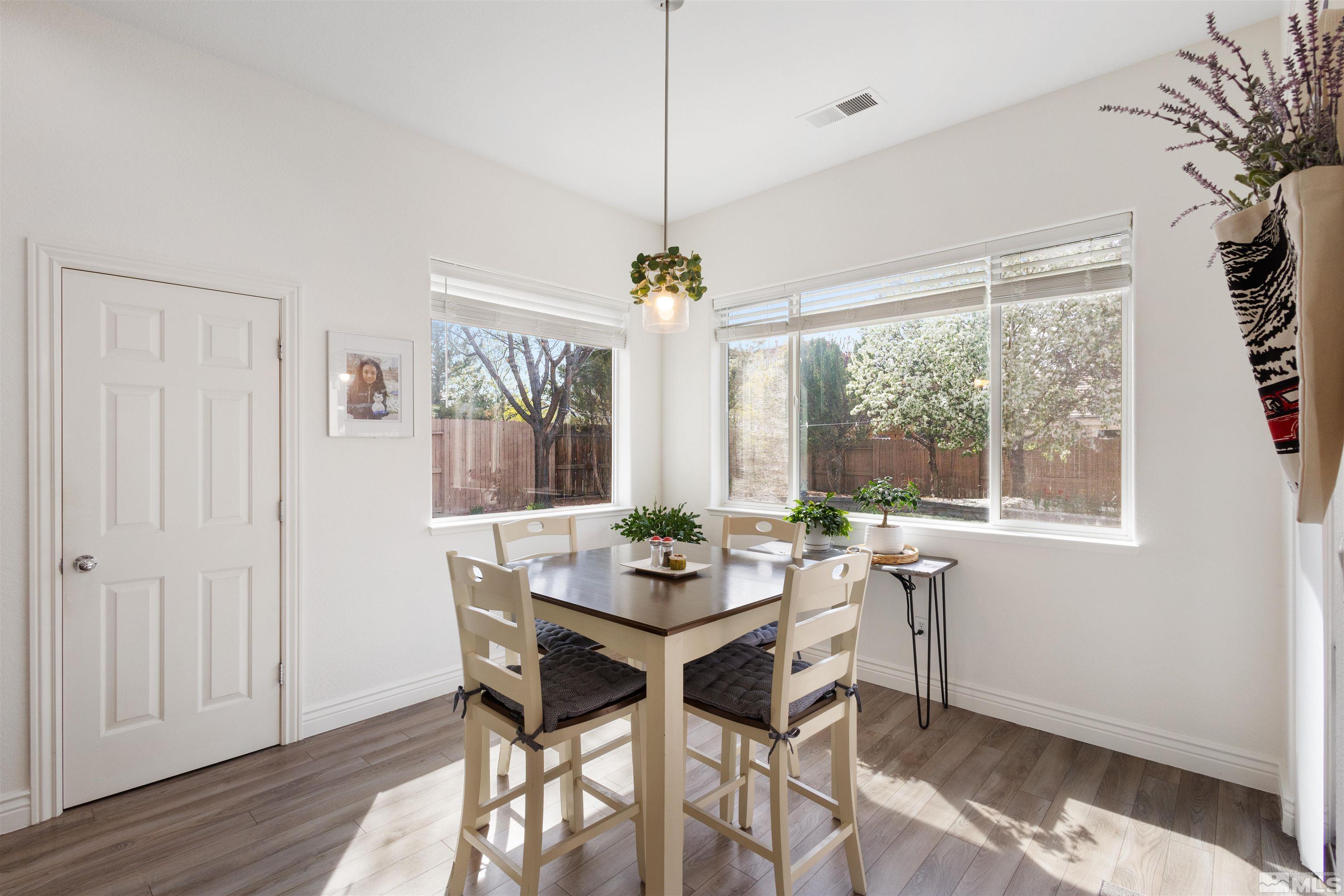 10521 Fort Morgan Way Reno, NV 89521 - Photo 11 of 35 a dining room with furniture window wooden floor