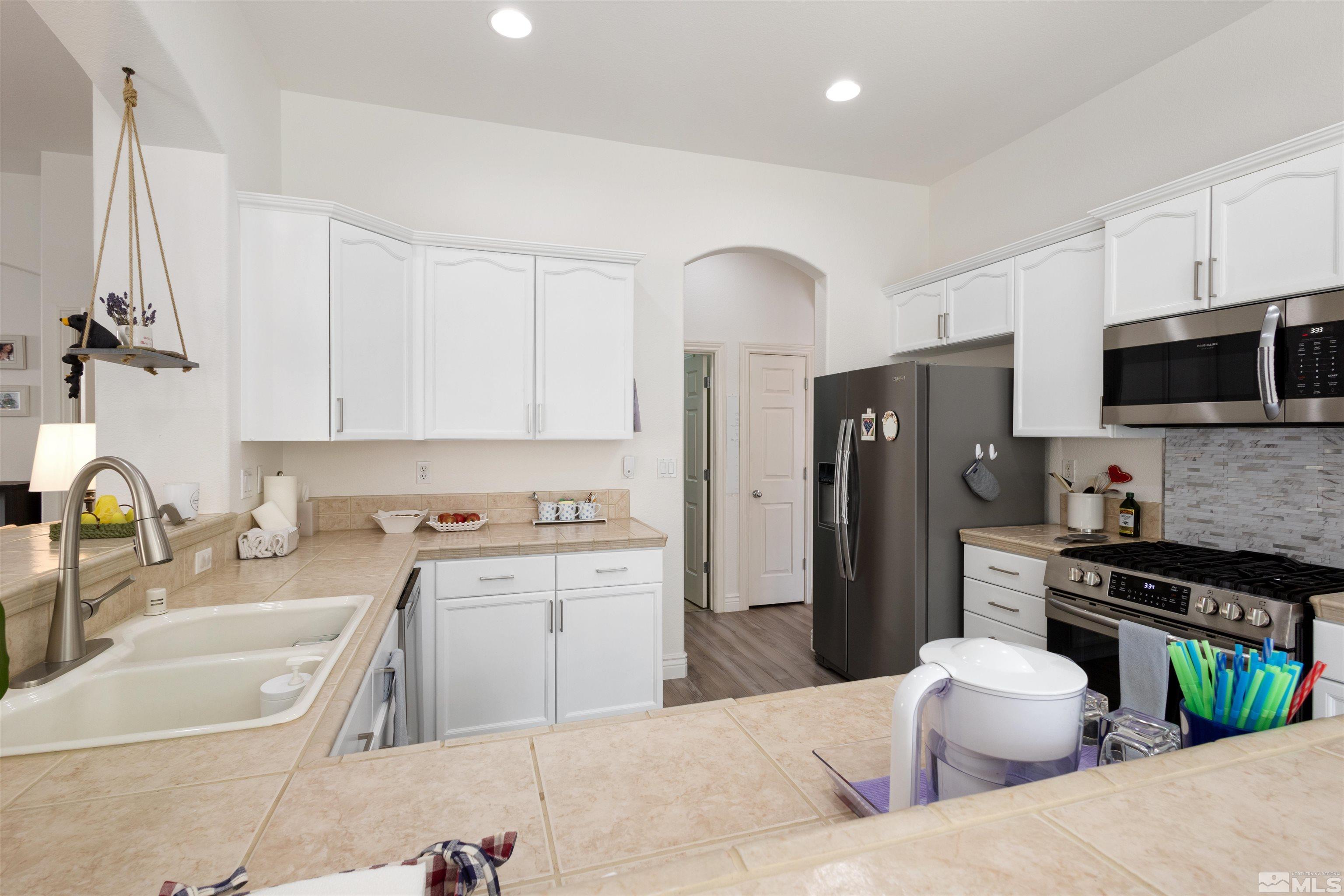 10521 Fort Morgan Way Reno, NV 89521 - Photo 13 of 35 a kitchen with a refrigerator stove top oven and sink