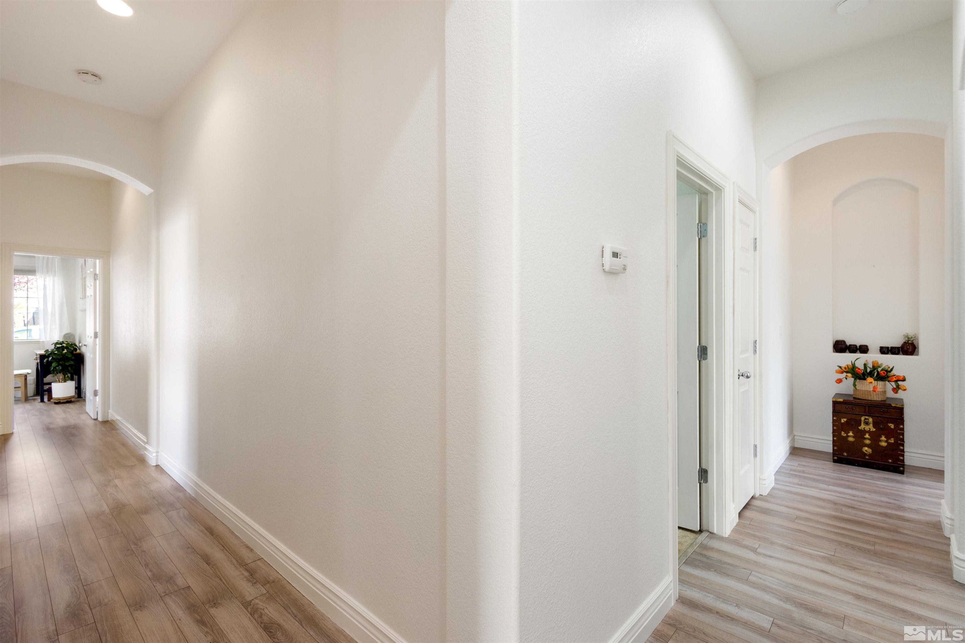 10521 Fort Morgan Way Reno, NV 89521 - Photo 18 of 35 a view of a hallway with wooden floor and a living room