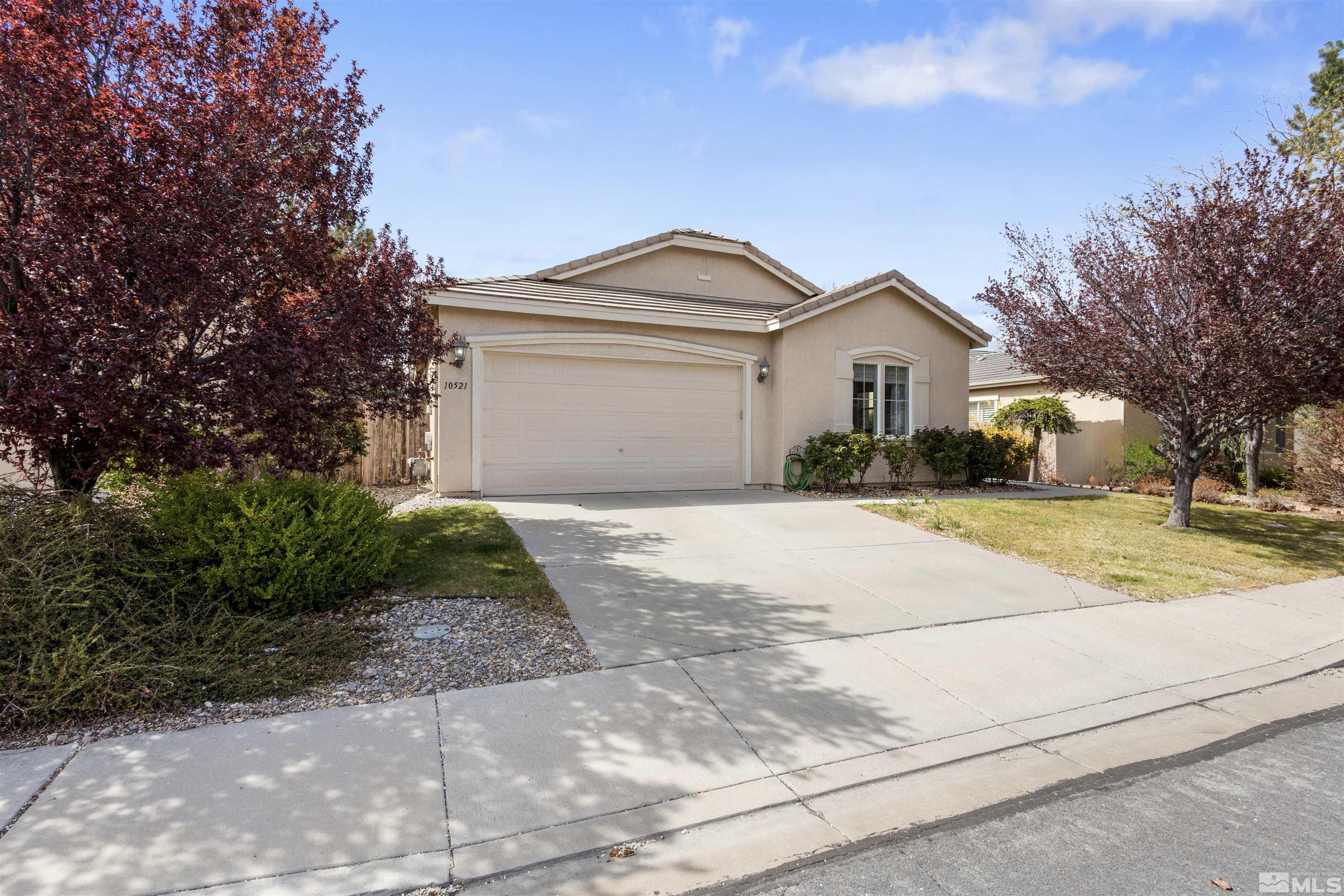 10521 Fort Morgan Way Reno, NV 89521 - Photo 2 of 35 a front view of a house with a yard and garage