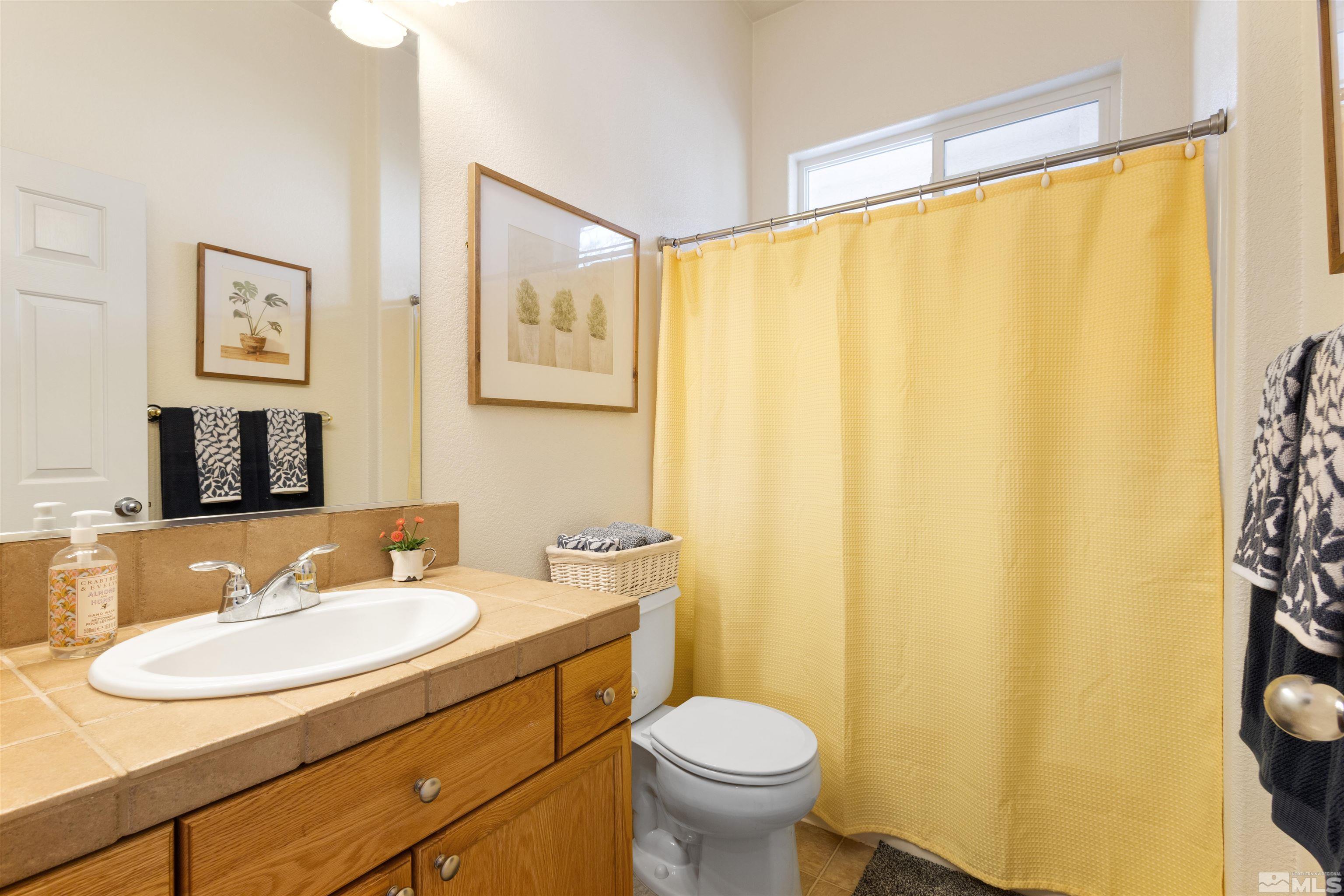 10521 Fort Morgan Way Reno, NV 89521 - Photo 26 of 35 a bathroom with a sink and a mirror