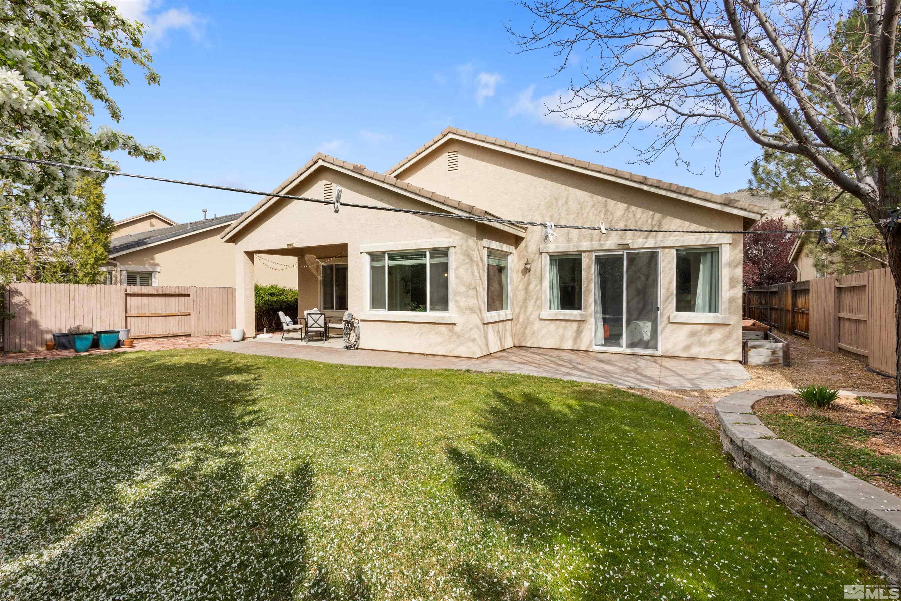 10521 Fort Morgan Way Reno, NV 89521 - Photo 35 of 35 a front view of a house with a yard table and chairs