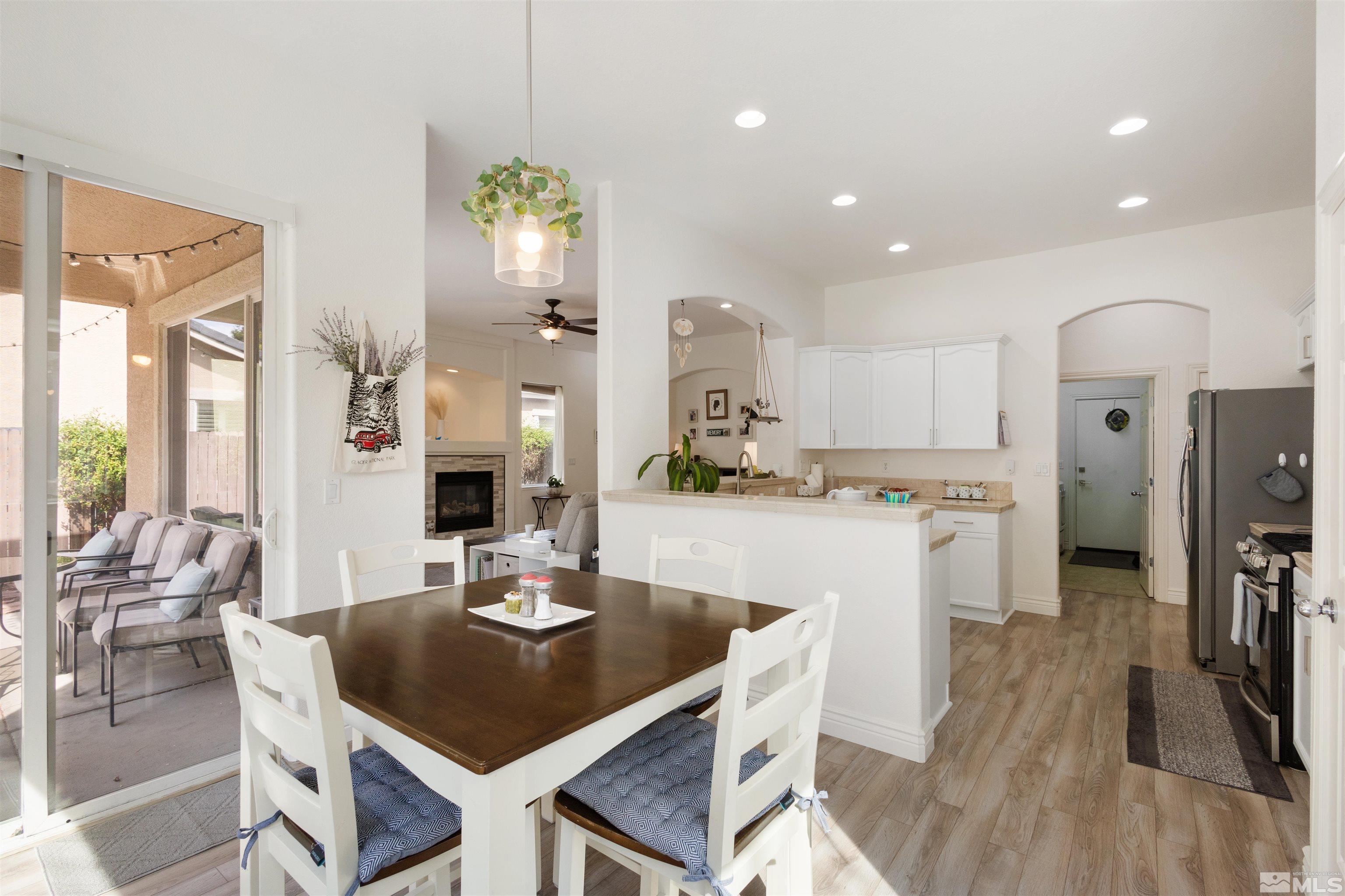 10521 Fort Morgan Way Reno, NV 89521 - Photo 10 of 35 a kitchen with a table chairs refrigerator and microwave