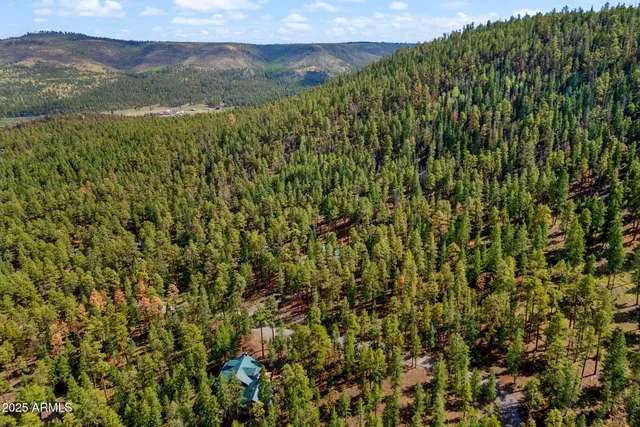 a view of backyard with swimming pool and sitting area