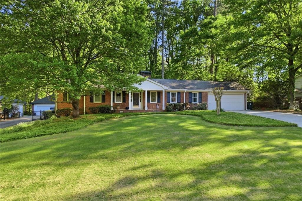 1837 Chancery Lane Atlanta, GA 30341 - Photo 1 of 46 a front view of a house with a garden