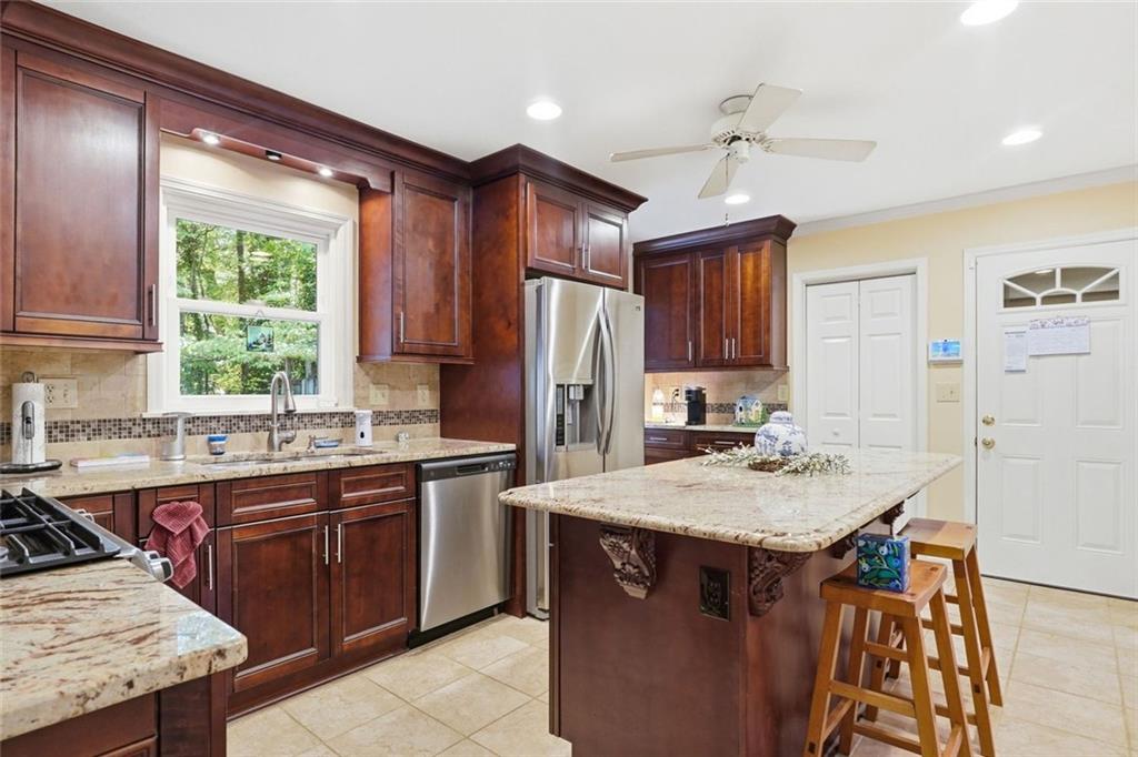 1837 Chancery Lane Atlanta, GA 30341 - Photo 12 of 46 a kitchen with a stove a sink a refrigerator and wooden cabinets